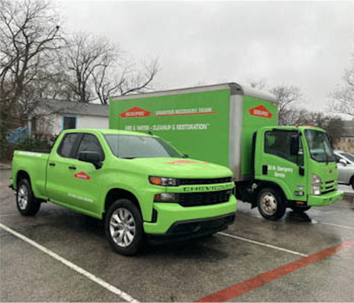 Two SERVPRO vehicles in a parking lot. 