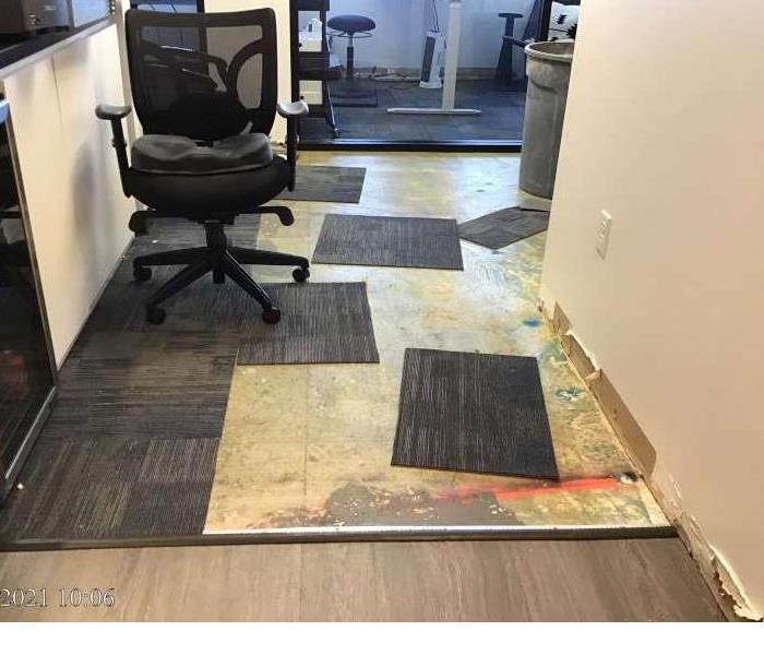 Office area with carpet squares taken off the ground.